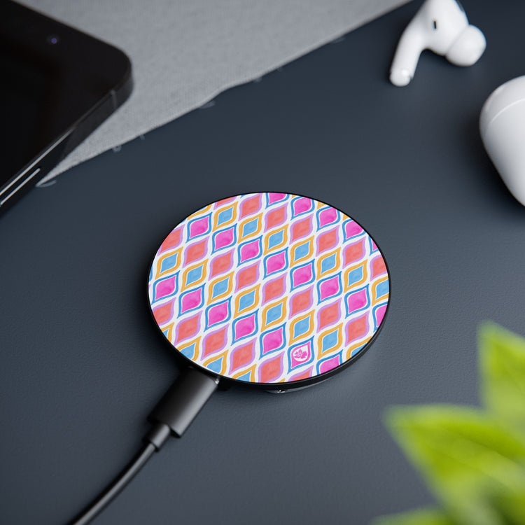 Painted Geo Patterned Magnetic Magsafe Phone Charger lying on desk edge next to airpods and desk plant