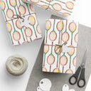Topspin Tennis Wrapping Paper on table with wrapping tape, string, and scissors and wrapped gifts in Tennis Grass Green Color Choice