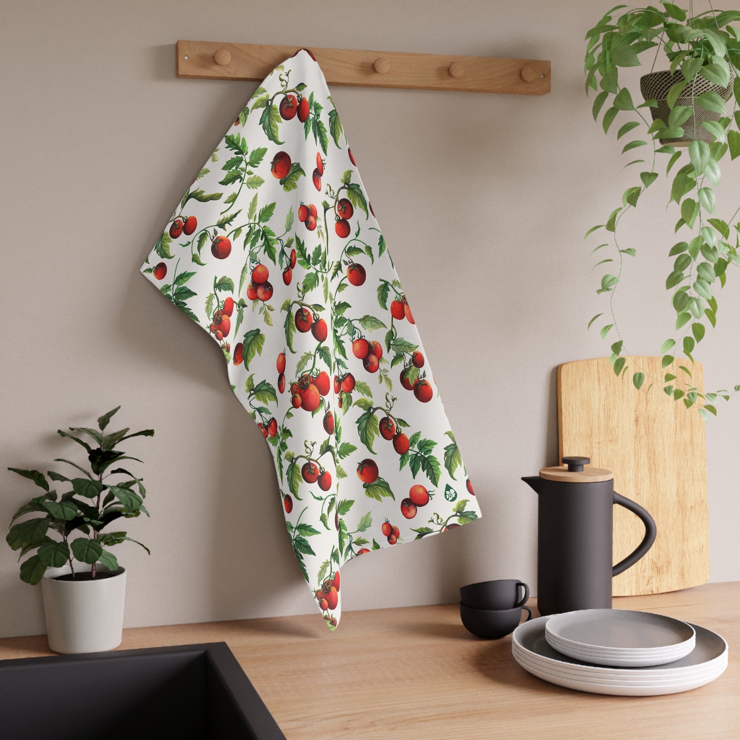 Tomato Tomato Patterned kitchen towel hanging on kitchen rack knob over counter next to sink and dishes