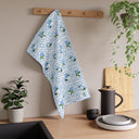 Garden Trellis Kitchen Towel hanging on dish towel knob in kitchen over counter in Cloudless Blue Colorway