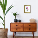 Botanical Hydrangea Study 02 Pink 8x10 in Gold Frame over 4 drawer cabinet with books and houseplant