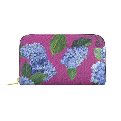 Floral patterned wallet with blue flowers and green leaves on a pink background
