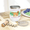 Good Dog Wine Tumbler with Green and purple Stripe on cutting board with plate of grapes and wine opener