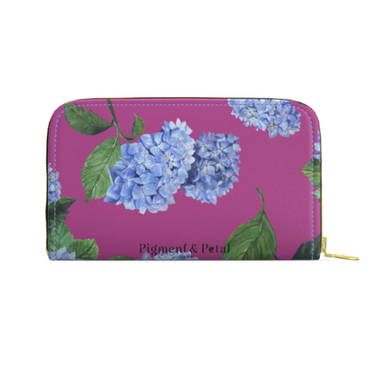 Floral wallet with blue flowers on a pink background, featuring the brand 'Pigment & Petal'.