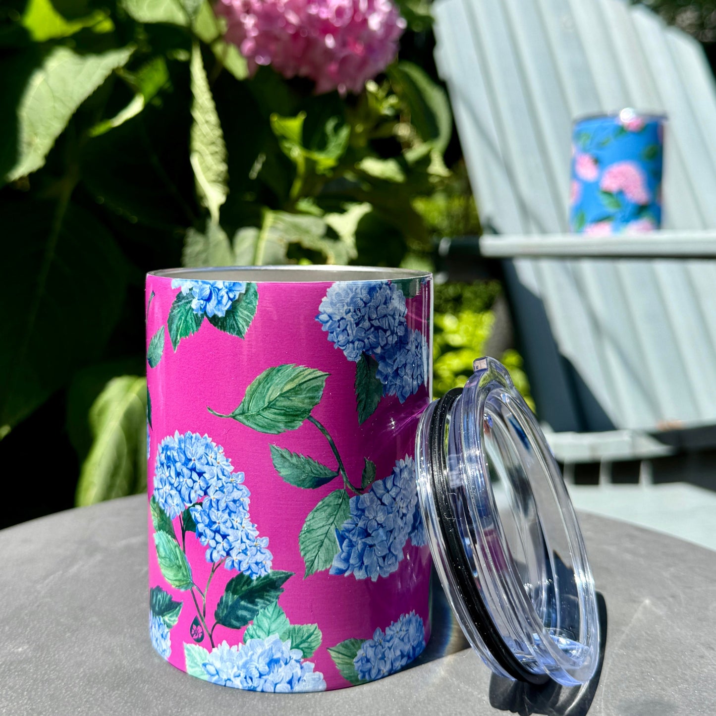 Hydrangea Tumbler in Peony on garden stool in garden with Adirondack chair and tumbler behind it