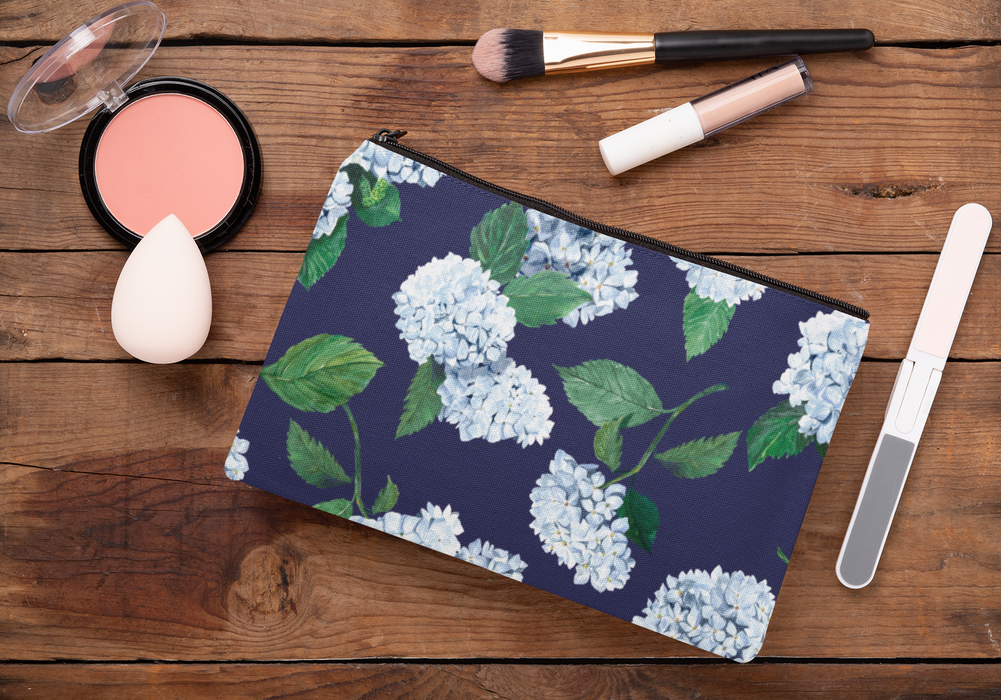 Hydrangea Zip Pouch in twilight Navy colorway on wood table with makeup