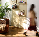 Founder-and-Artist-Chelsea-Soisson-Walking-past-pigment-and-petal-studio-handbags-in-sunlit-studio