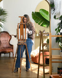 artist-chelsea-soisson-painting-custom-artwork-in-a-sunlit-studio-at-a-vintage-easel