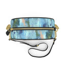 A cylindrical crossbody bag with a blue and green watercolor pattern, featuring a gold zipper, gold lion-head hardware, and a black leather strap on a white background.
